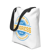 White tote bag with blue and yellow design on a white background