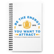 Notebook with motivational quote and logo on a white background
