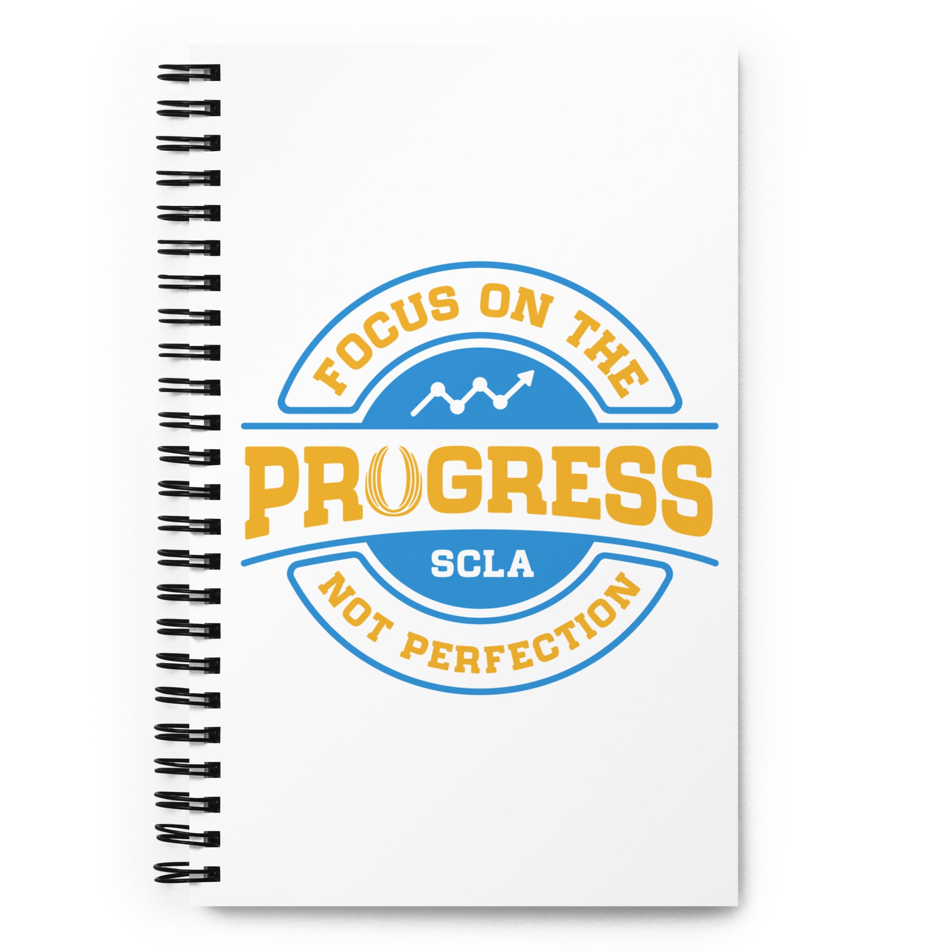 Notebook with 'Focus on the Progress, Not Perfection' design on a white background