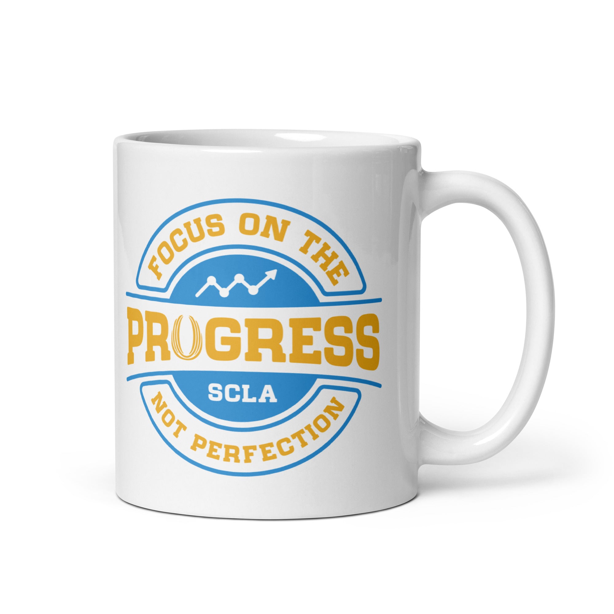 White mug with motivational quote 'Focus on the progress, not perfection' in blue and yellow on a white background
